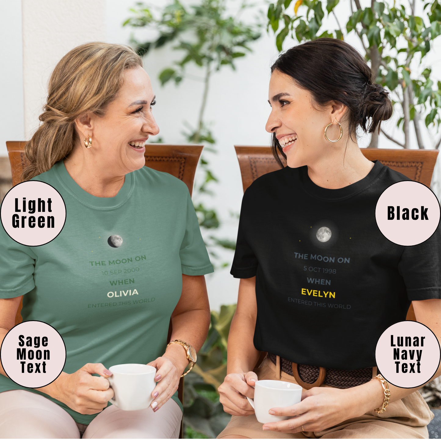Two women sitting outdoors, wearing t-shirts with text and graphics about the moon.