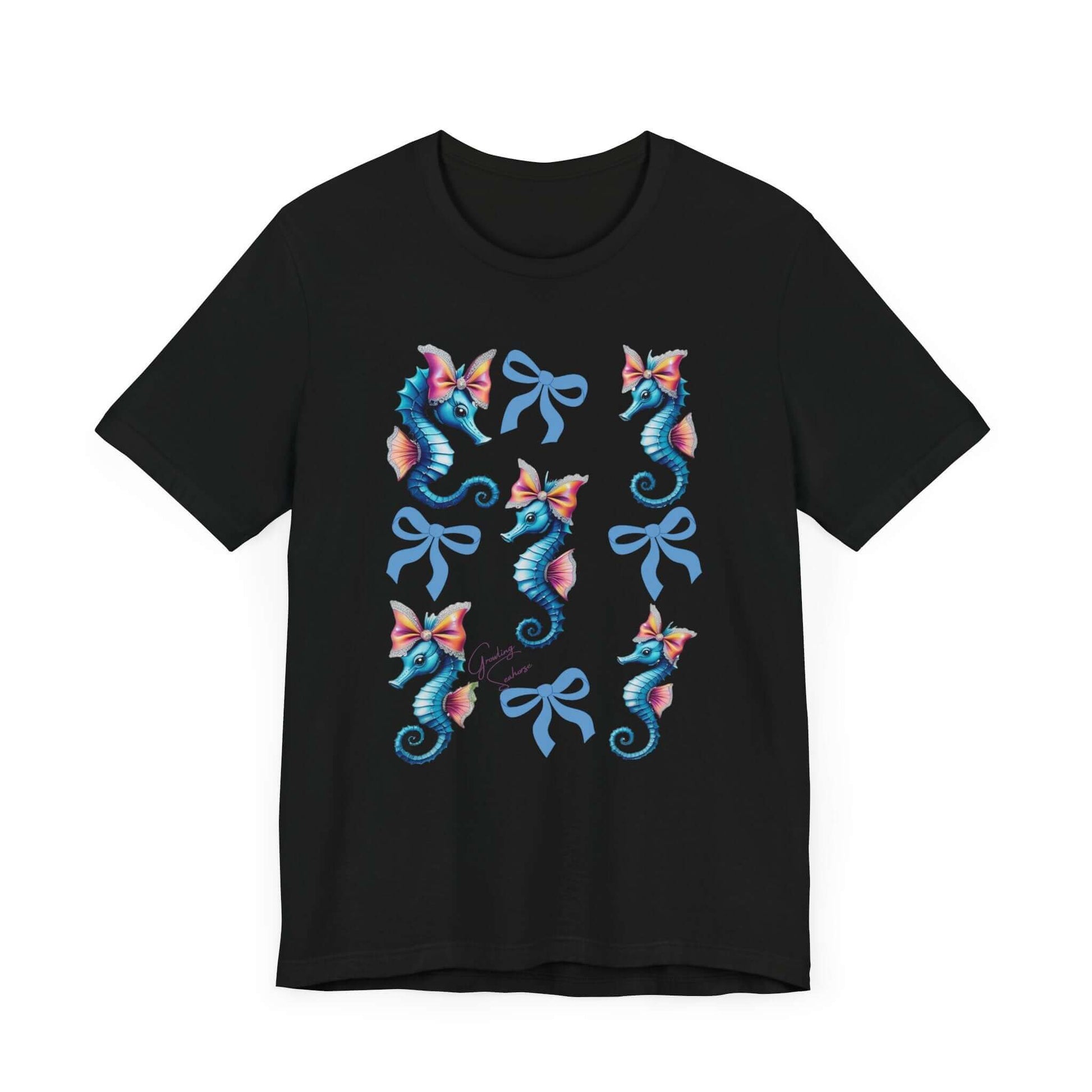 Black tee with a symmetrical pattern of cute, colorful seahorses and elegant bows arranged in a grid layout. The design radiates soft girl energy, vintage whimsy, and undersea coquette vibes — ideal for bold apparel and quirky fashion.