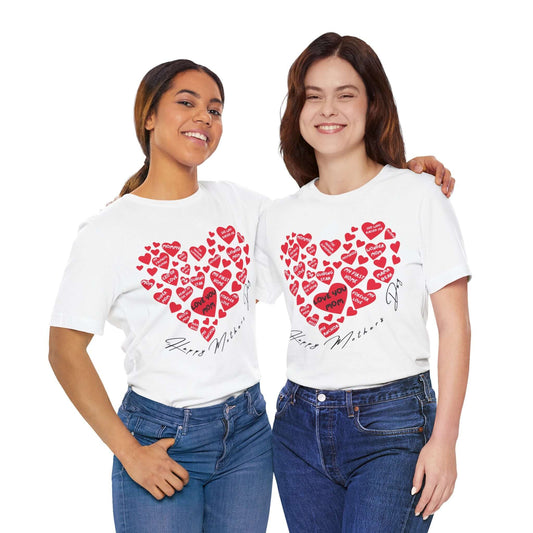Two smiling women wearing white t-shirts featuring a large red heart made of smaller hearts with mom-centric phrases like “Love You Mom,” paired with handwritten “Happy Mother’s Day” text. An emotional t-shirt celebrating motherhood in bold, quirky fashion.