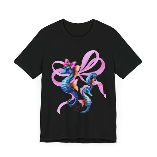 Black t-shirt featuring a trio of pastel seahorses decorated with large pink bows. The design pops against the dark background, making it a perfect blend of bold apparel and soft girl aesthetic.