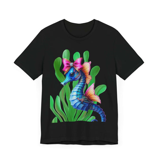 Black t-shirt with a brightly colored seahorse featuring a shiny pink bow, soft coral-colored fins, and surrounded by lush green seaweed. An artsy, coquette fashion design for bold apparel lovers and soft girl aesthetic fans.